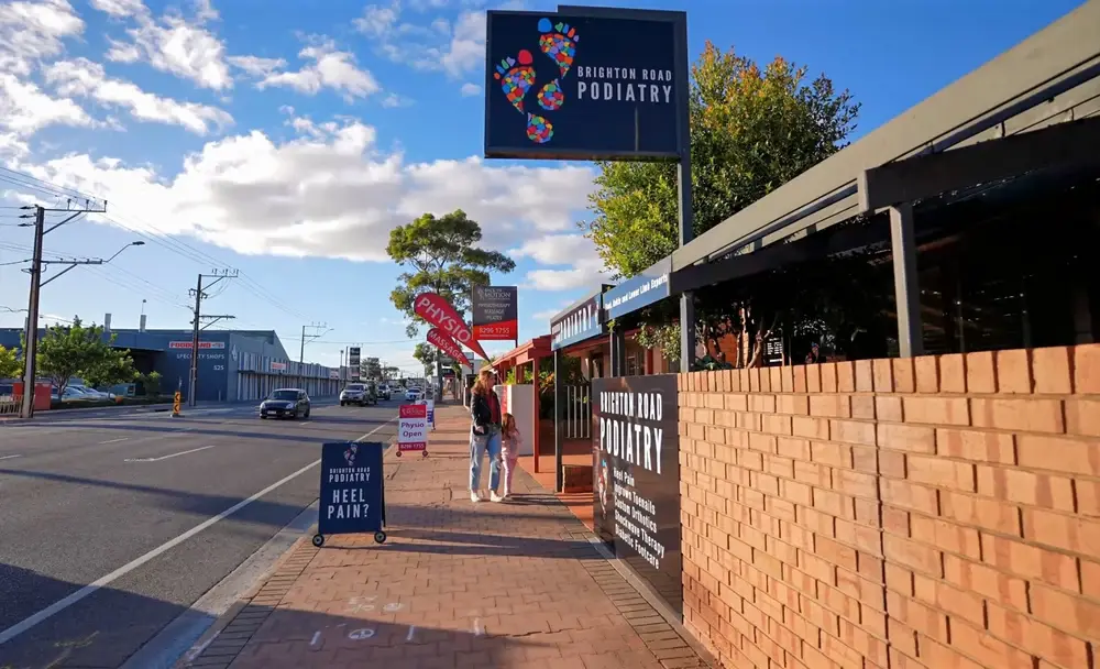 Exterior of Brighton Road Podiatry clinic on Brighton Road, Brighton SA, with signage and a mother and daughter walking to the entrance